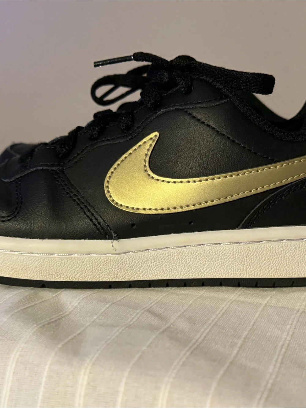 Nike Kids Black Sneakers with Gold Swoosh